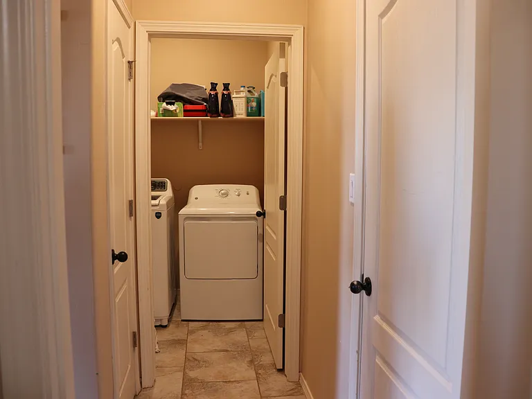 laundry room with pantry door on the left garage door on the right.