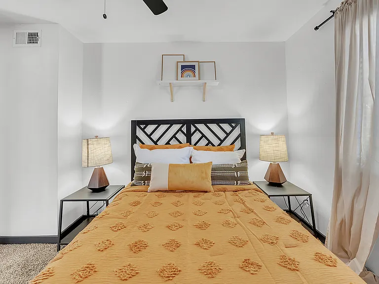 Experience comfort and style in this beautifully designed bedroom space.