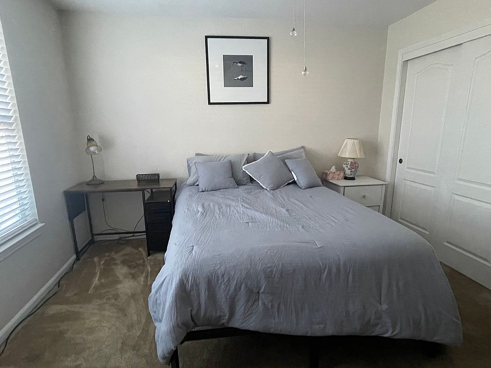 A desk for personal use. A comfortable queen sized bed.