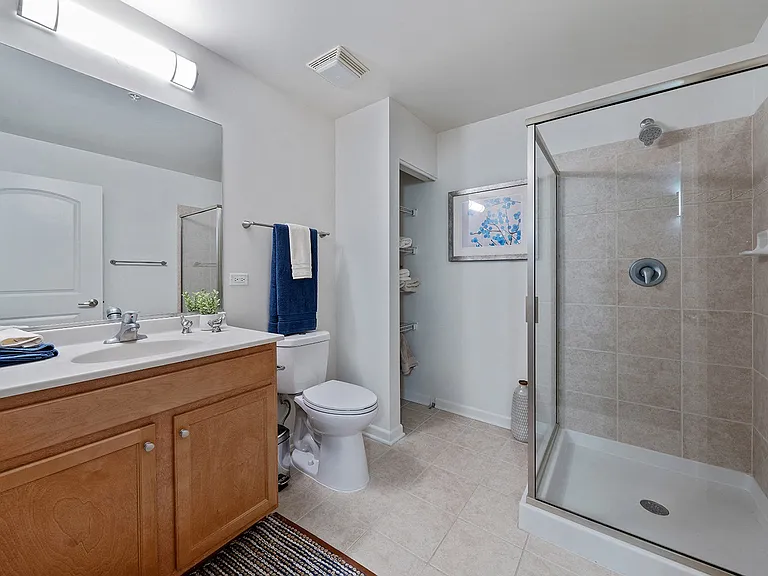 Bathroom with glass shower and wood vanity