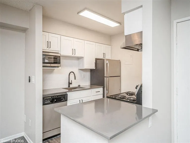 Overhead lighting and cabinets for all kitchen necessities