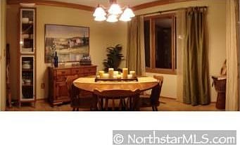 dining room with new fixture and wood floor