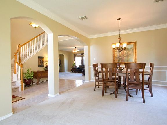 Bright and open floor plan with double crown molding and neutral paint throughout