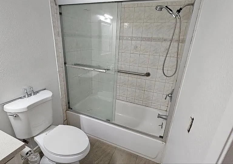 Full shower with bathtub, toilet with bidet (old picture doesn't show), and sink