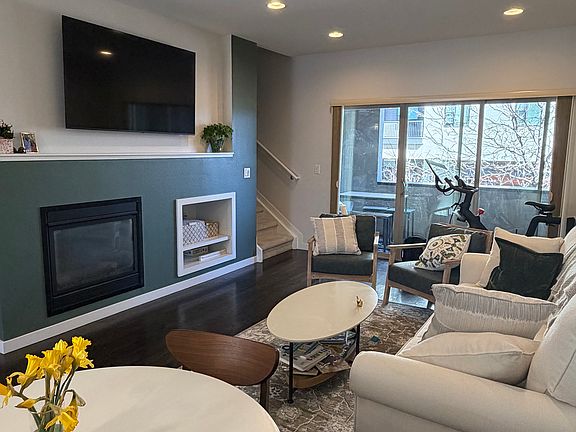 Living room with updated paint and space for a dining table, couch(es), a peloton, and more.