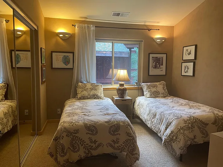 Guest room with a trundle bed that can be configured into twin beds or one single for more space. Desk and printer in this room which can be used as an office.