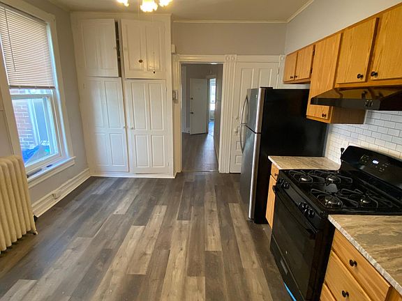 Kitchen showing modern flooring with food pantry for lots of storage