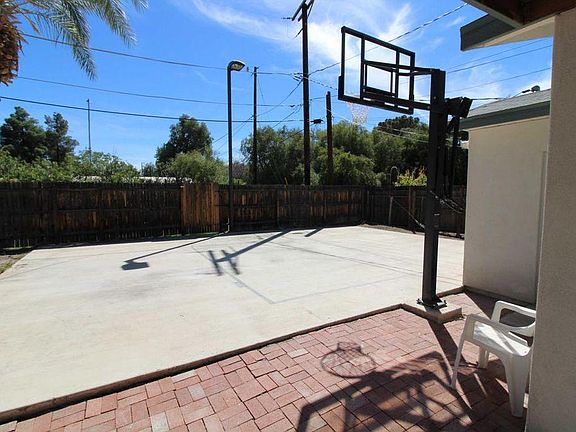 Lighted Basketball Court in back of house