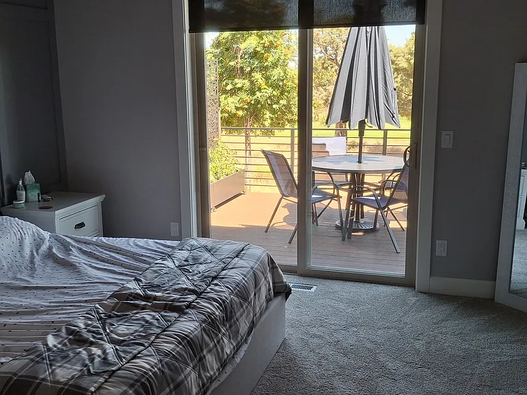 Master bedroom with walk in closet and king size bed.