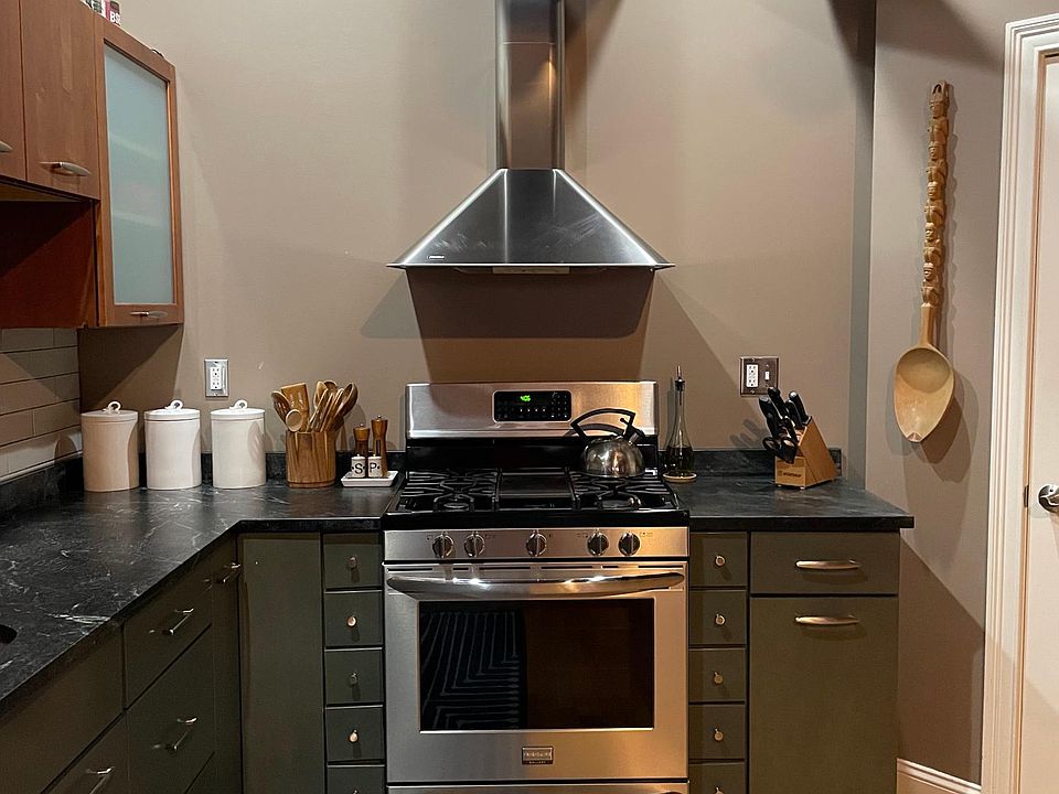 Kitchen with gas stove and soapstone countertops