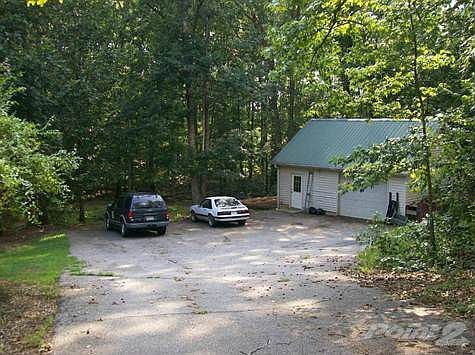 Long Asphalt Driveway With Ample Parking