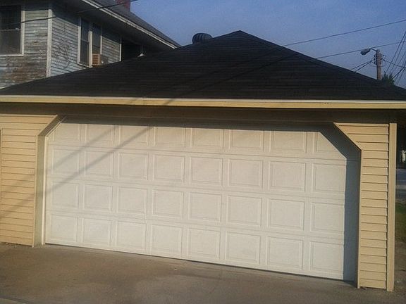 2 car garage showing new siding and new roof