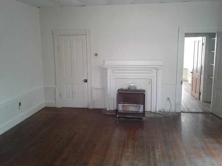 Nice large room that can be used as a bedroom. The opening on the right is a closet the leads to the front bedroom.