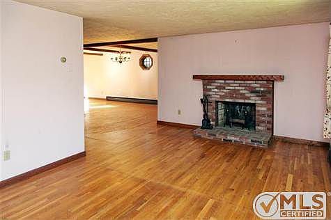 Living room with hardwood flooring and fireplace and bay window