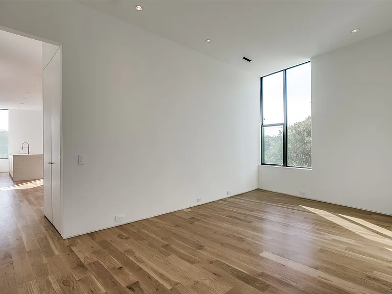 Interior space featuring wood-finish flooring, recessed lighting, and a large corner window