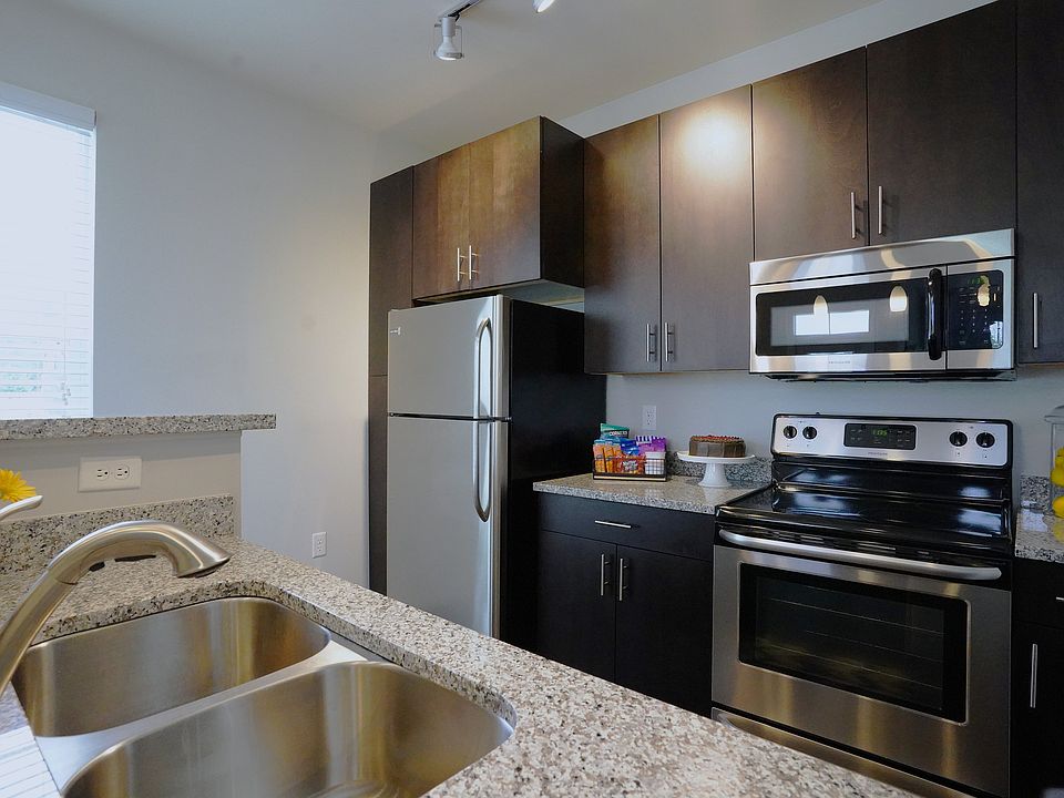 Dark cabinets, granite countertops, and stainless steel shine_this kitchen is equal parts style and function.