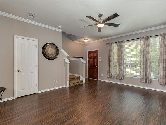 Living room is bright and open with new wood look tile flooring.