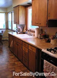 Kitchen has deep oak cabinets