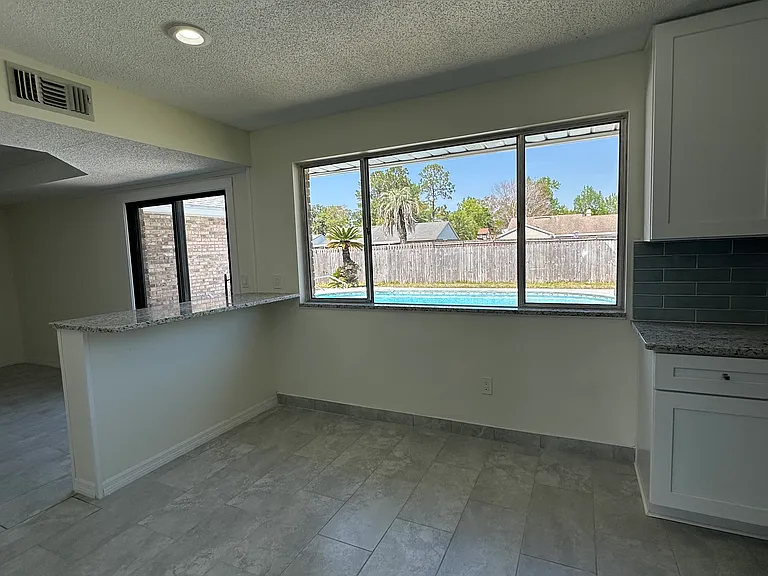 kitchen space overlooking the pool and backyard area