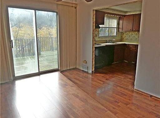 The formal dining room is open to the kitchen and has a sliding door to deck.