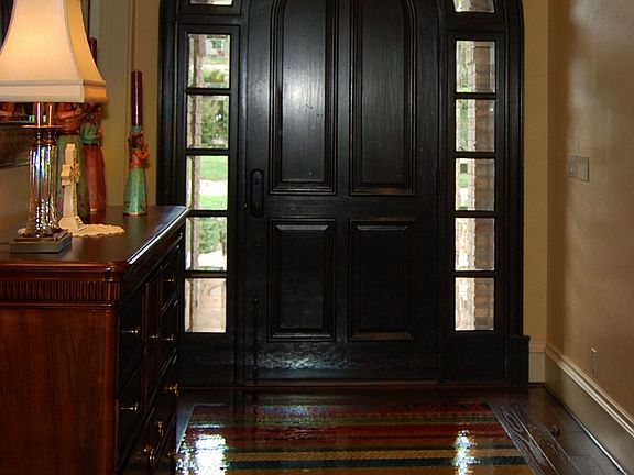 Foyer features an inlaid tiled rug.