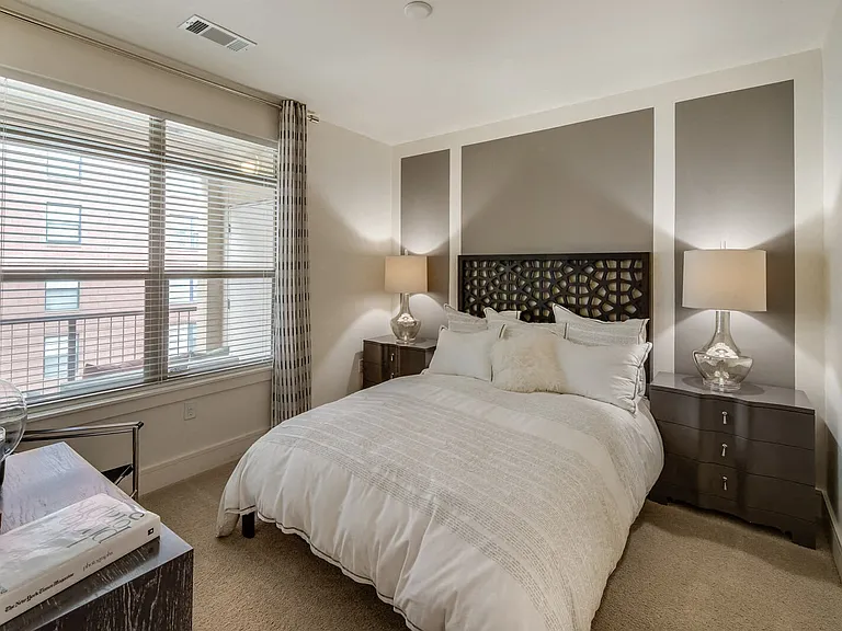 Enjoy the comfort of plush carpeting and natural light streaming through large windows in your bedroom.