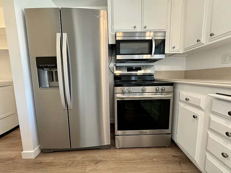 Light & Bright kitchen with new appliances (Refrigerator, Stove, Microwave & Dishwasher) new blinds, vinyl plank flooring and paint!