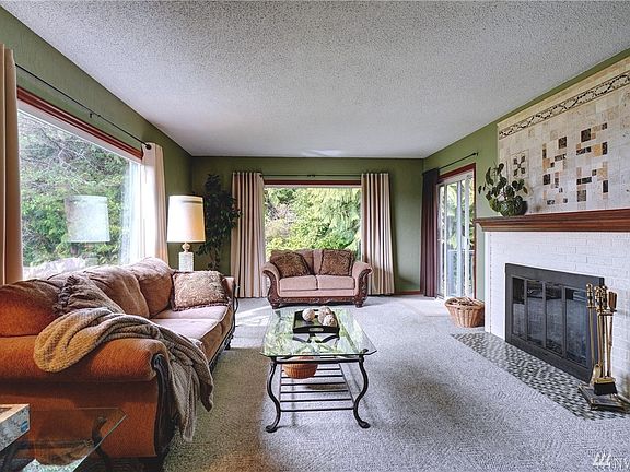 A cozy brick fireplace with rich wood mantel to converse around. 