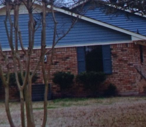 Side of house next to road 