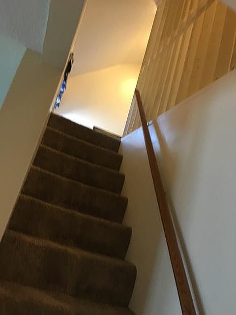 Stairs lead to two small rooms.