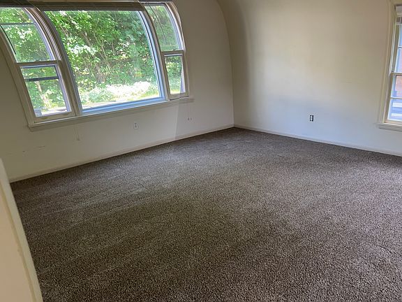 Large picture window in living room. Two more windows on the other side.