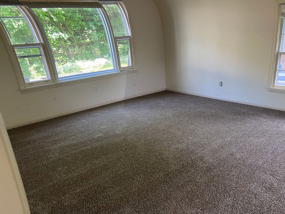 Large picture window in living room. Two more windows on the other side.
