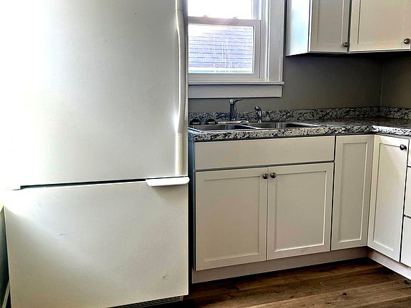 Completely renovated kitchen with new appliances. This view is coming in from the side door, which also goes to the basement.