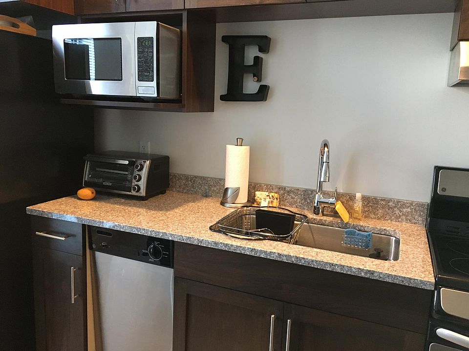 Stainless steel kitchen appliances - Microwave, dishwasher, stove, garbage disposal.