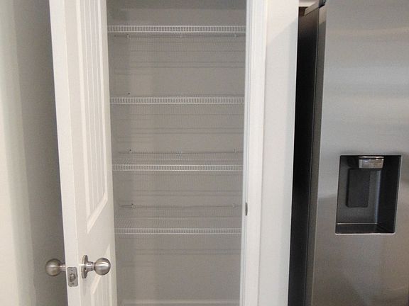 he kitchen is spacious and modern, it comes with steel appliances, and crown cabinetry for a unique