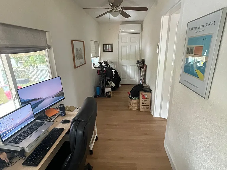 Front porch/office has a closet at one end, with its own mini-split A/C unit and ceiling fan.