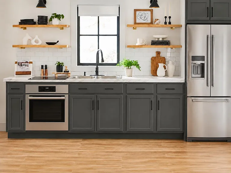 Stylish kitchen with stainless steel fridge, built-in oven, generous cabinetry, and a double-basin sink under the window.