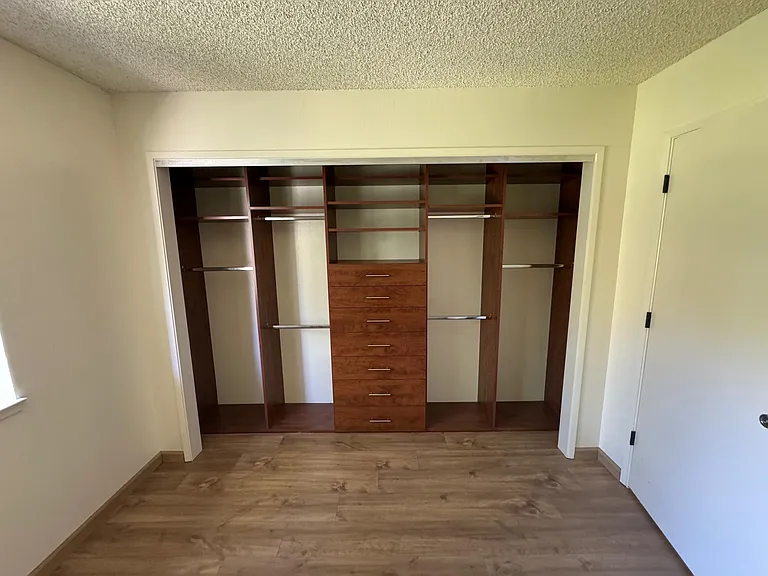 Custom closet organizing system with drawers in each bedroom