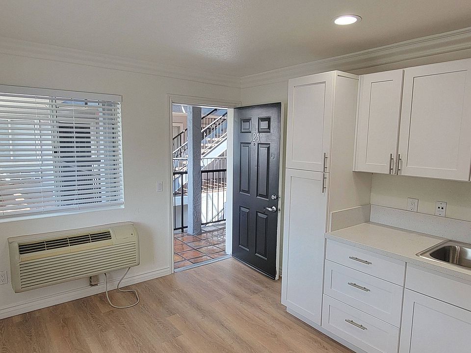 One bedroom apartment kitchen area with white cabinets at the Atrium Apartments in San Diego, CA.
