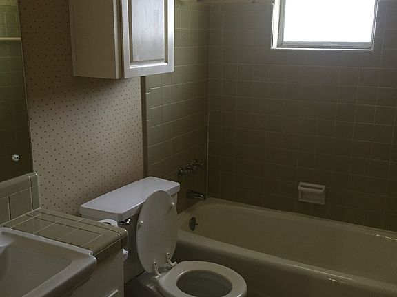 hallway bathroom with bathtub