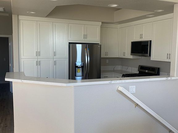 Brand new kitchen cabinetry, quartz counters, and stainless steel appliances.