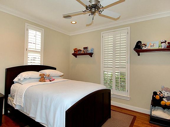 Downstairs bedroom with wood floors and step in closet.