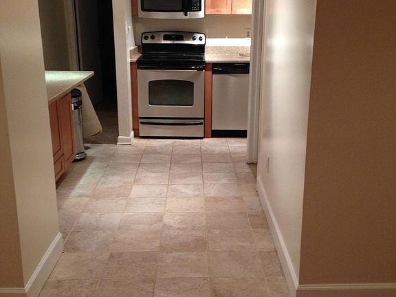 Kitchen hallway toward rear bedroom entrance on the left