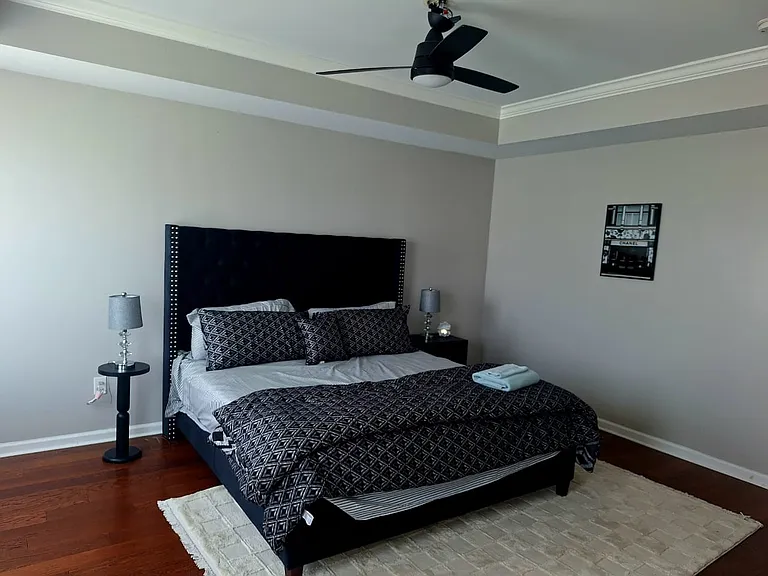 A comfortable guest bedroom with a queen bed, premium bedding, and a peaceful atmosphere for a restful night's sleep.