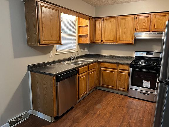 kitchen with new stainless steel appliances, Fridge, gas stove, and dishwasher
