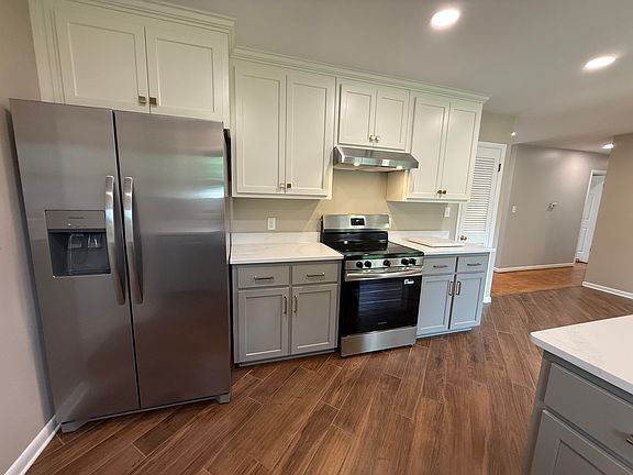 New kitchen cabinets, beautiful quartz countertops and peninsula, perfect for bar seating, new sink and faucet fixtures. New appliances in kitchen: stove/oven, refrigerator, dishwasher. Adjacent mudroom/laundry room/ pantry with fresh paint and flooring.
