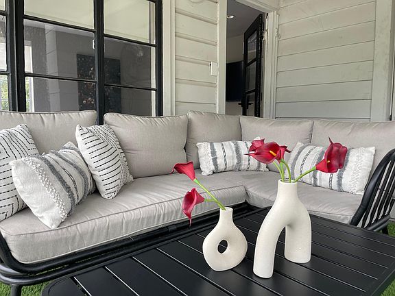 Sectional seating in the outdoor covered balcony just off the upstairs primary bedroom