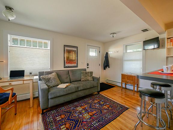 Walk in to an open 15' x 15' open floor plan. View of the living area, a glimpse of the breakfast bar and work space (left). Sofa is a pull out queen size bed for the occasional guest.