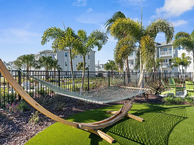 Relax in a serene outdoor escape amidst elegant apartment living.