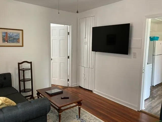 Living room off kitchen with built in storage